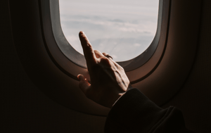 Pointing out airplane window